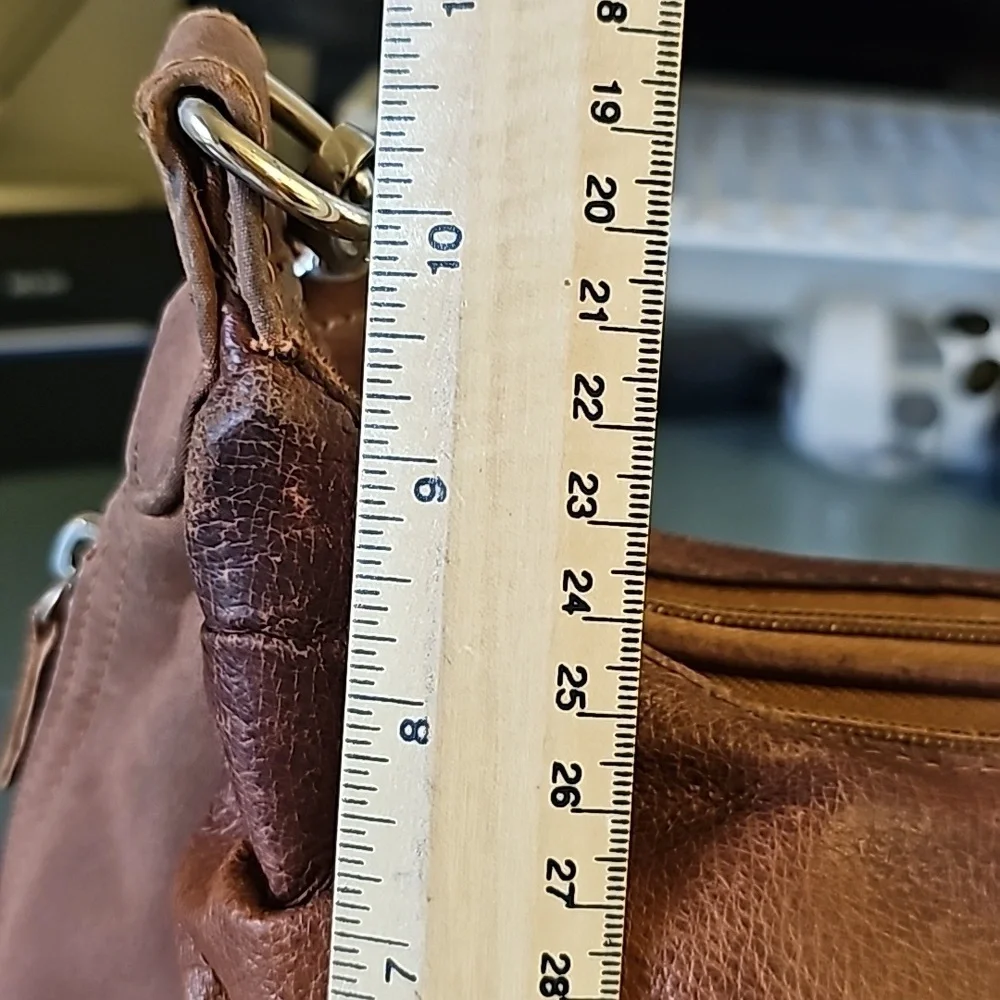 Gun tote'n Momas, leather bag. Lots of zippers‎ and pockets.